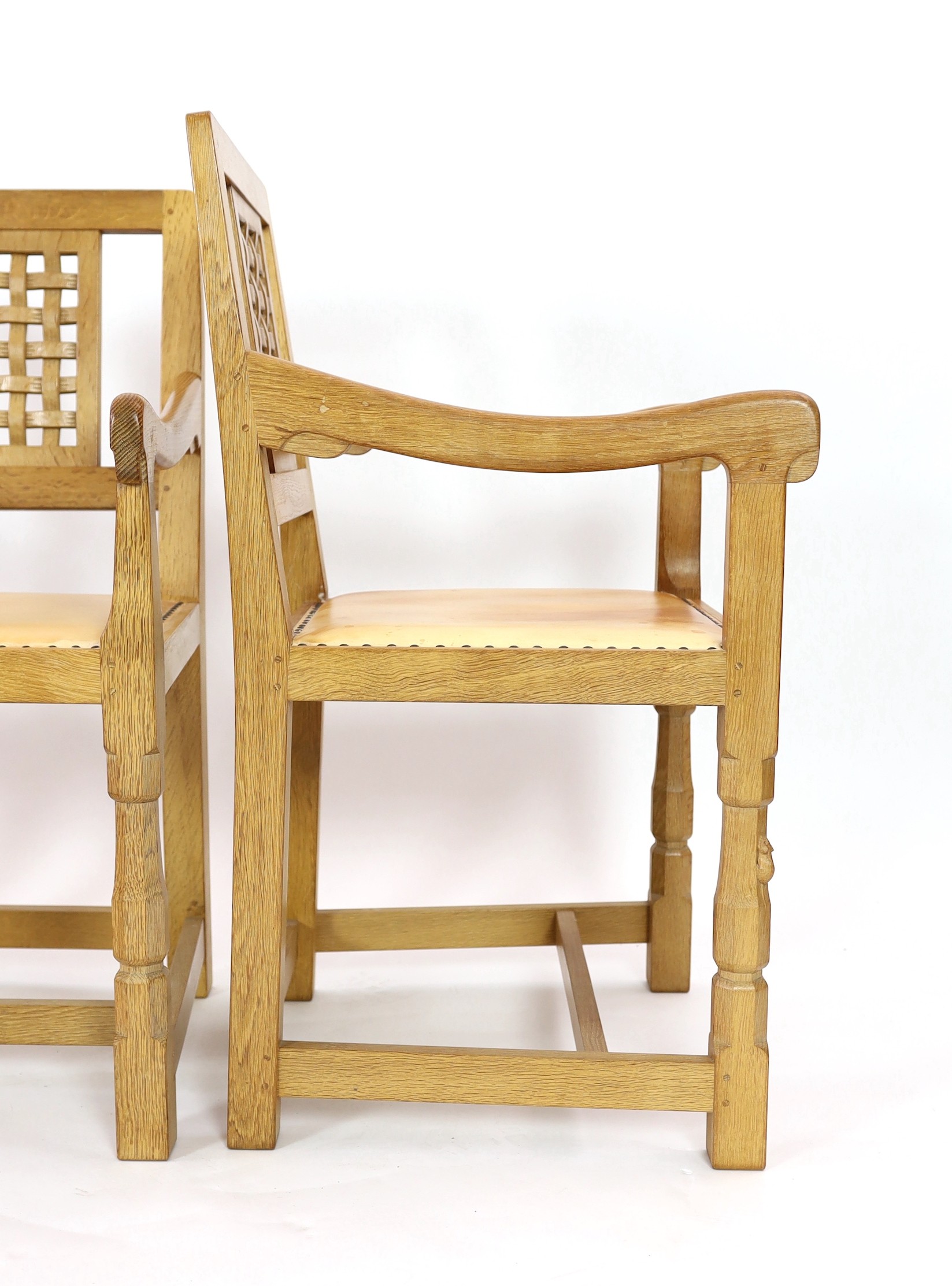 A set of four Robert Thompson 'Mouseman' oak armchairs W.52cm D.52cm H.90cm